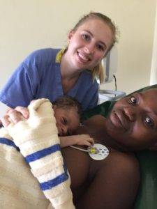Madeline Anderson smiles with a mother and baby at Yala hospital