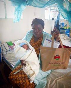 A new mother receives a "mama pack" with essentials for her newborn